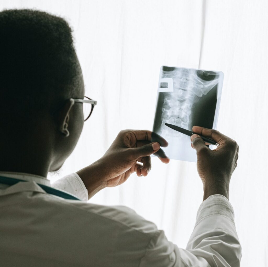 A physician looks at an x-ray